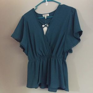 Monteau Los Angeles large cross neck blue blouse